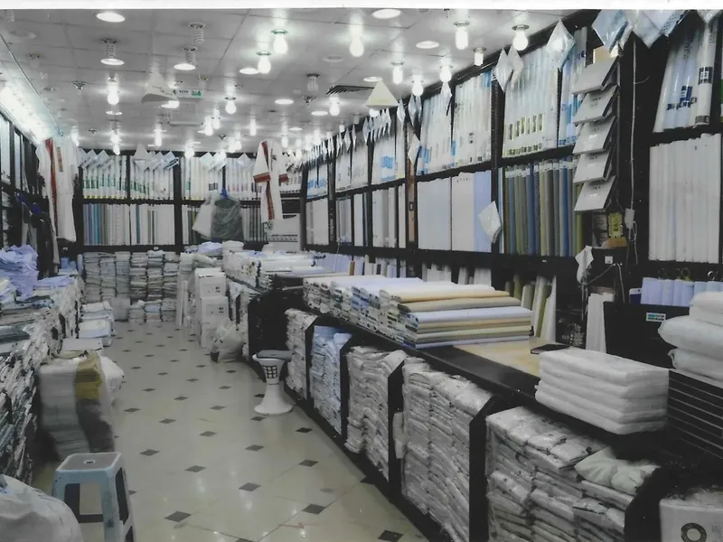 Shelves and bolts of fabric inside the old Bab Sharif branch before demolition