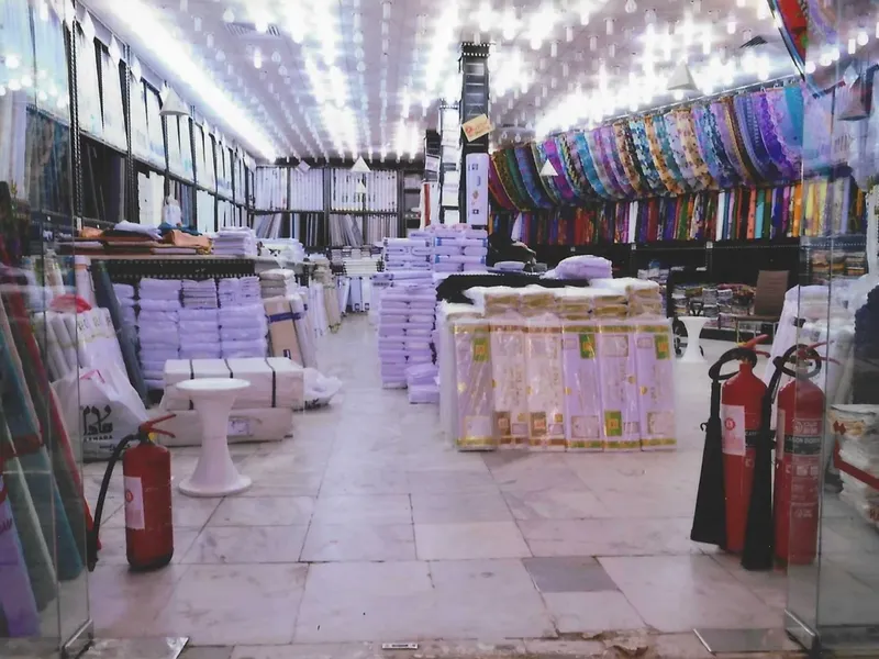 The old branch aisle with bolts of fabric stacked, before demolition