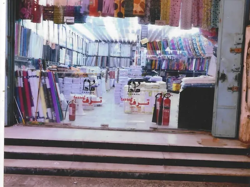 The entrance of an old branch with coloured fabrics hanging