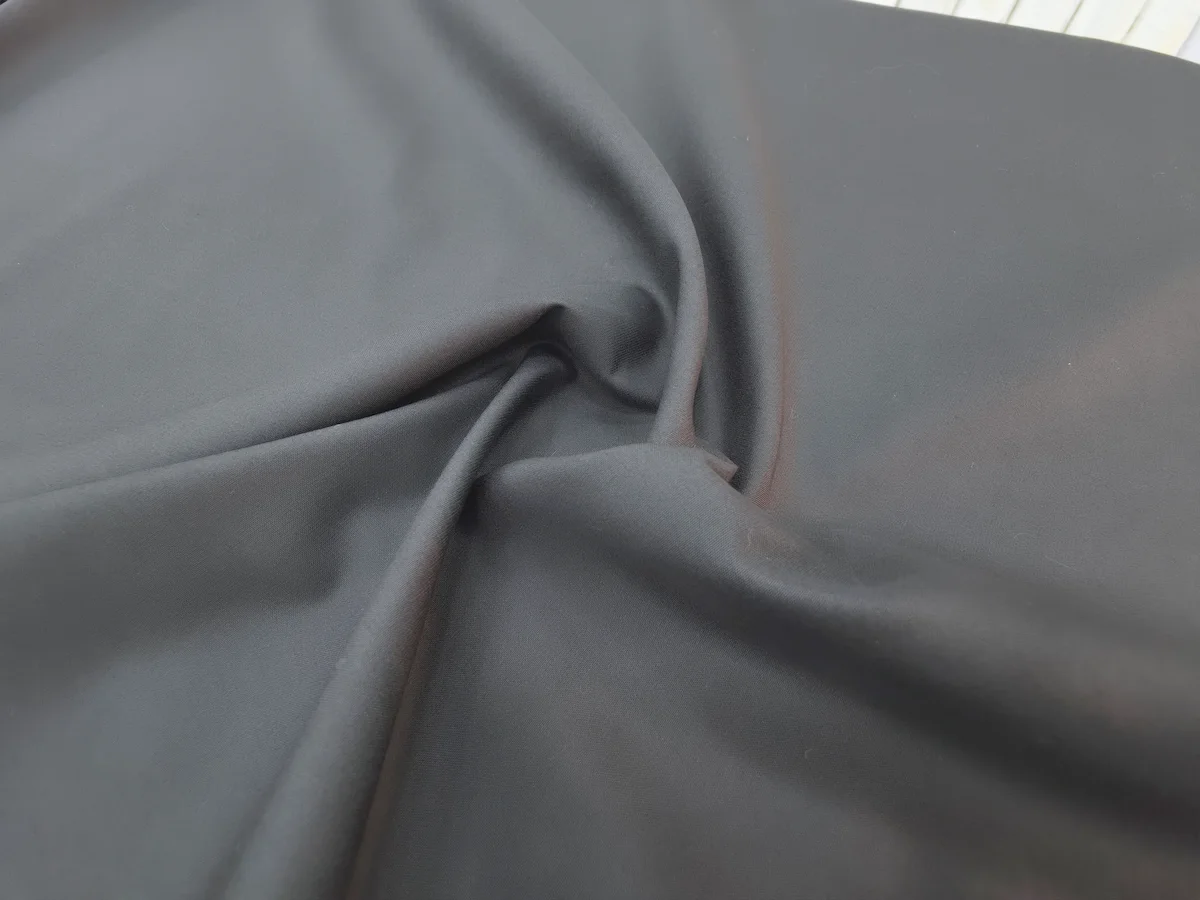 Charcoal polyester fabric in soft folds