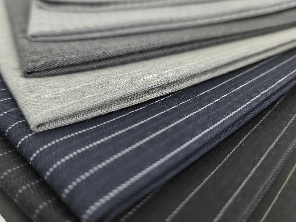 Winter fabric samples with fine white lines on grey and blue grounds