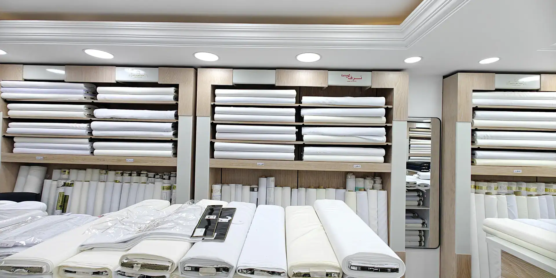 Shelves and rolls of white fabric inside the Medina Road branch, Jeddah