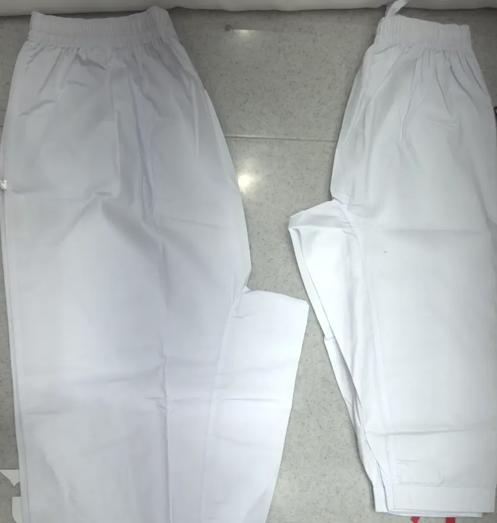 Two white trousers laid flat