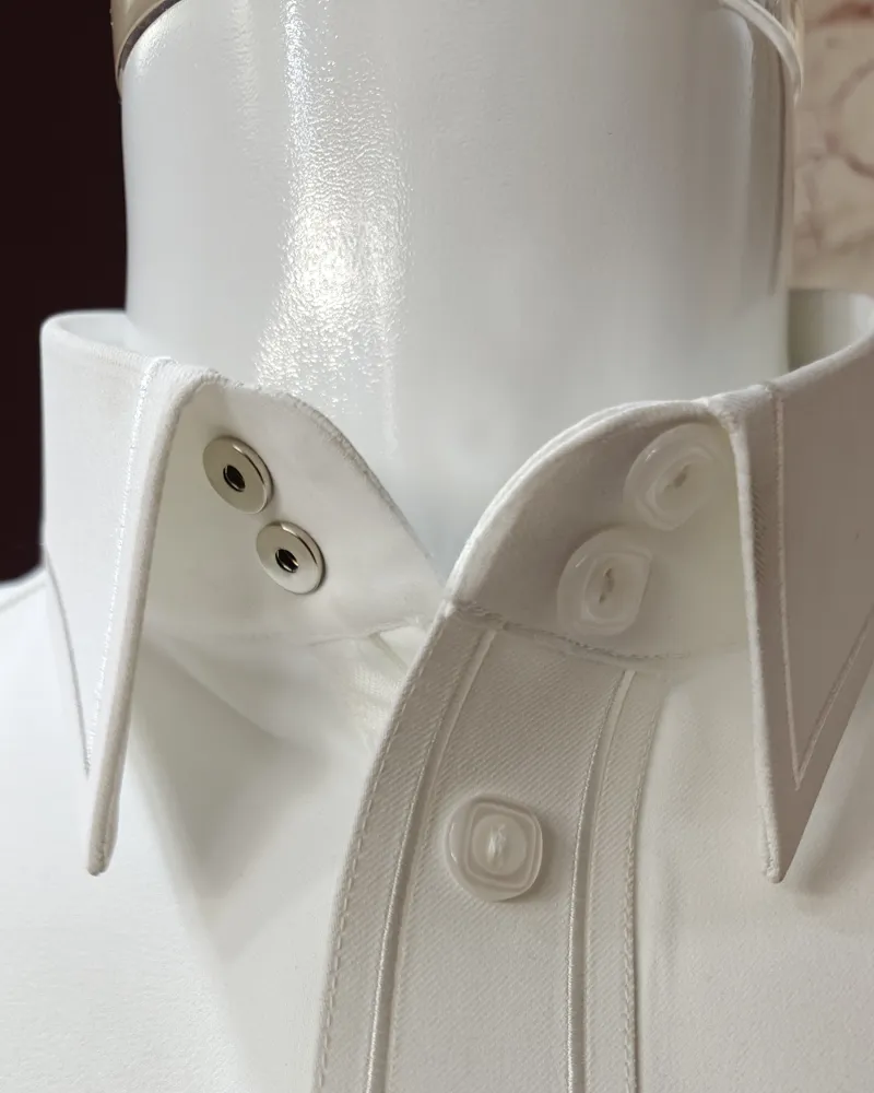 Collar and button stitching details on a white thobe